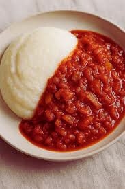 Rich tomato‐onion South African gravy poured over mielie‐meal pap and roast meat