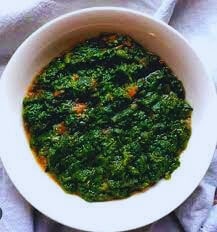 Fresh pumpkin leaves, flowers, tomato, onion, and peanuts — key ingredients for making Thanga.